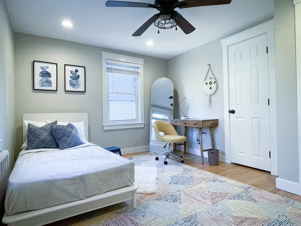 a bedroom with a bed and a chandelier