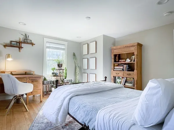 a bedroom with a bed and a chair