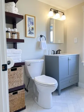 a bathroom with a toilet a sink and mirror