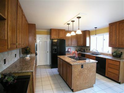 4104 Wallace Road Santa Rosa, CA 95404 - Photo 7 of 9 a kitchen with stainless steel appliances granite countertop a stove a sink dishwasher and a refrigerator