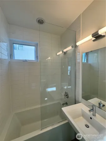 a bathroom with a sink and shower