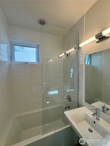 a bathroom with a sink and shower