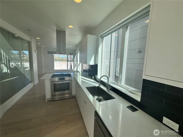a kitchen with a sink and large window