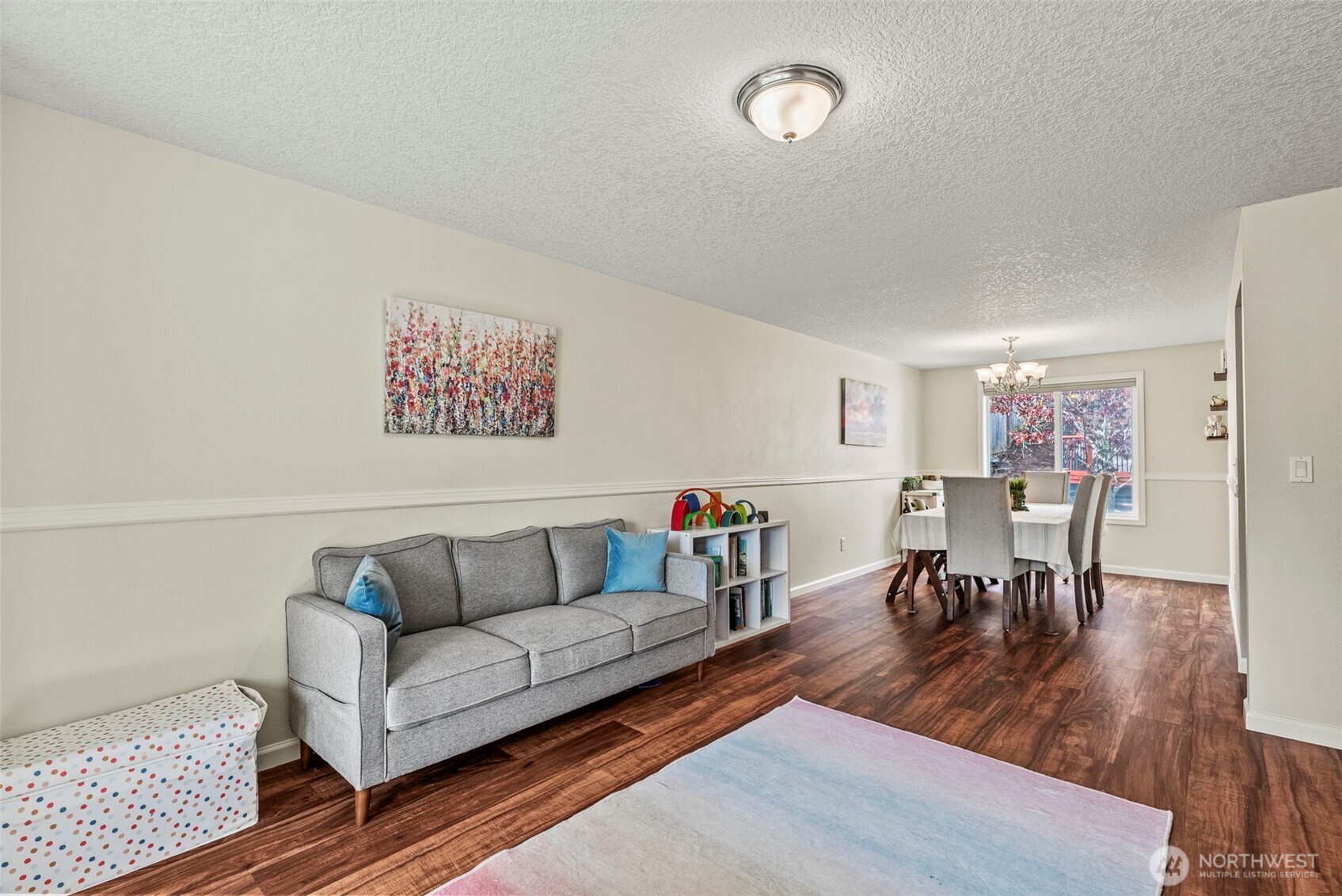 2410 North Heron Drive Ridgefield, WA 98642 - Photo 15 of 40 a living room with furniture and a dining table with wooden floor