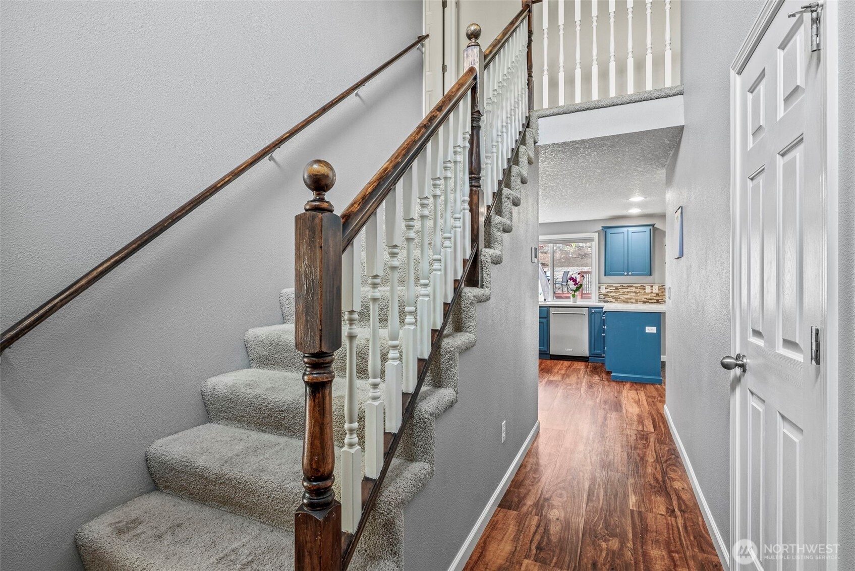 2410 North Heron Drive Ridgefield, WA 98642 - Photo 18 of 40 a view of a hallway with wooden floor and staircase