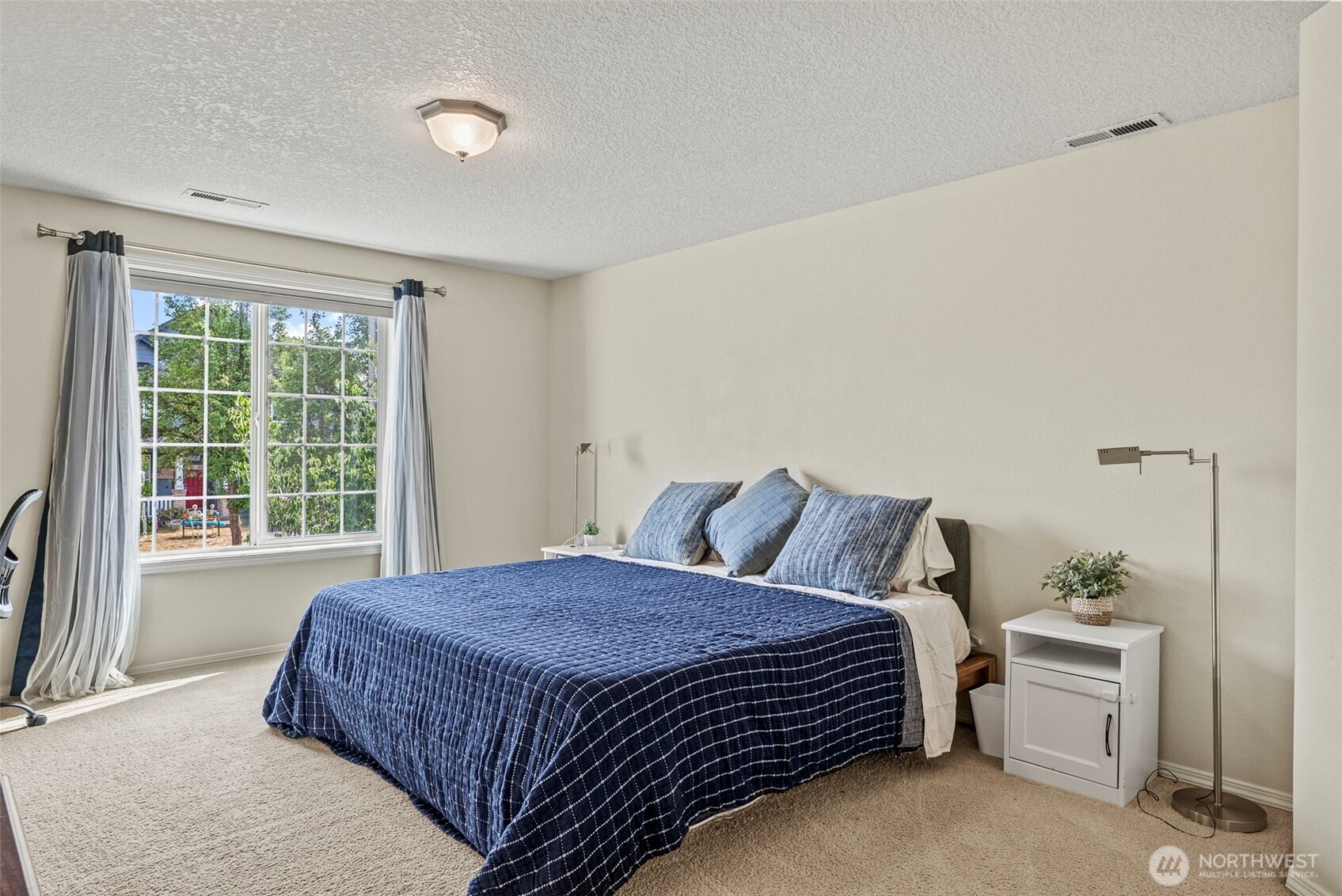 2410 North Heron Drive Ridgefield, WA 98642 - Photo 20 of 40 a large bed sitting in a bedroom next to a window