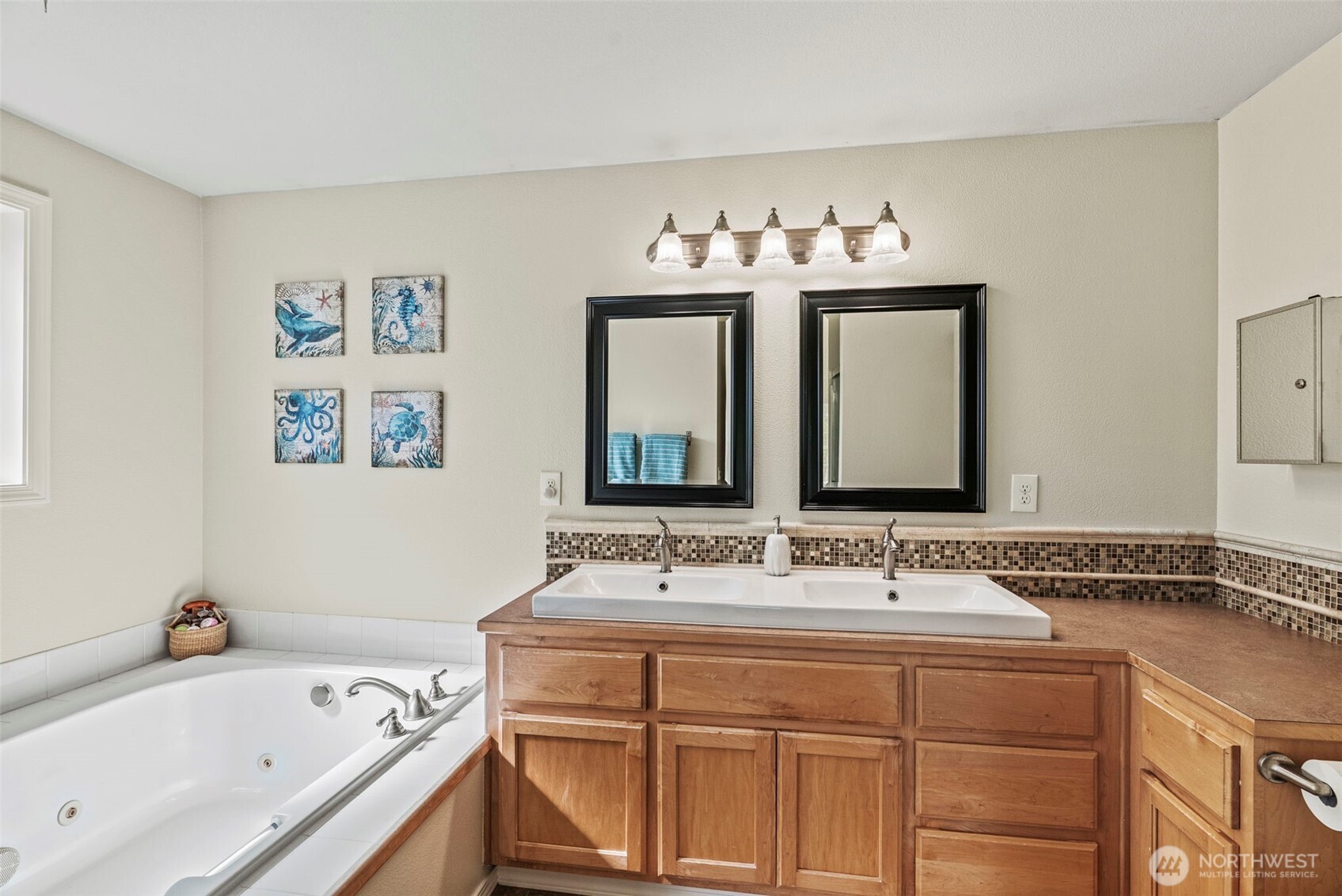 2410 North Heron Drive Ridgefield, WA 98642 - Photo 23 of 40 a bathroom with a sink and a bathtub