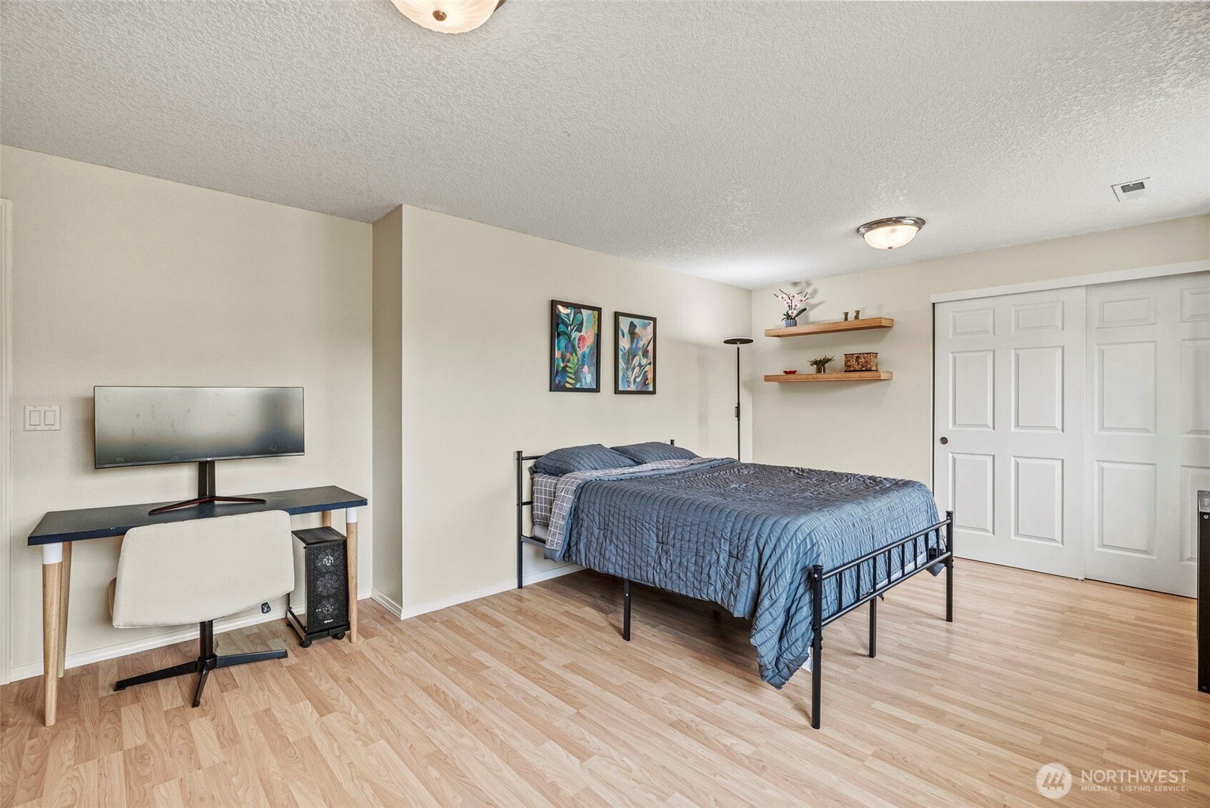 2410 North Heron Drive Ridgefield, WA 98642 - Photo 26 of 40 a bedroom with a bed and wooden floor