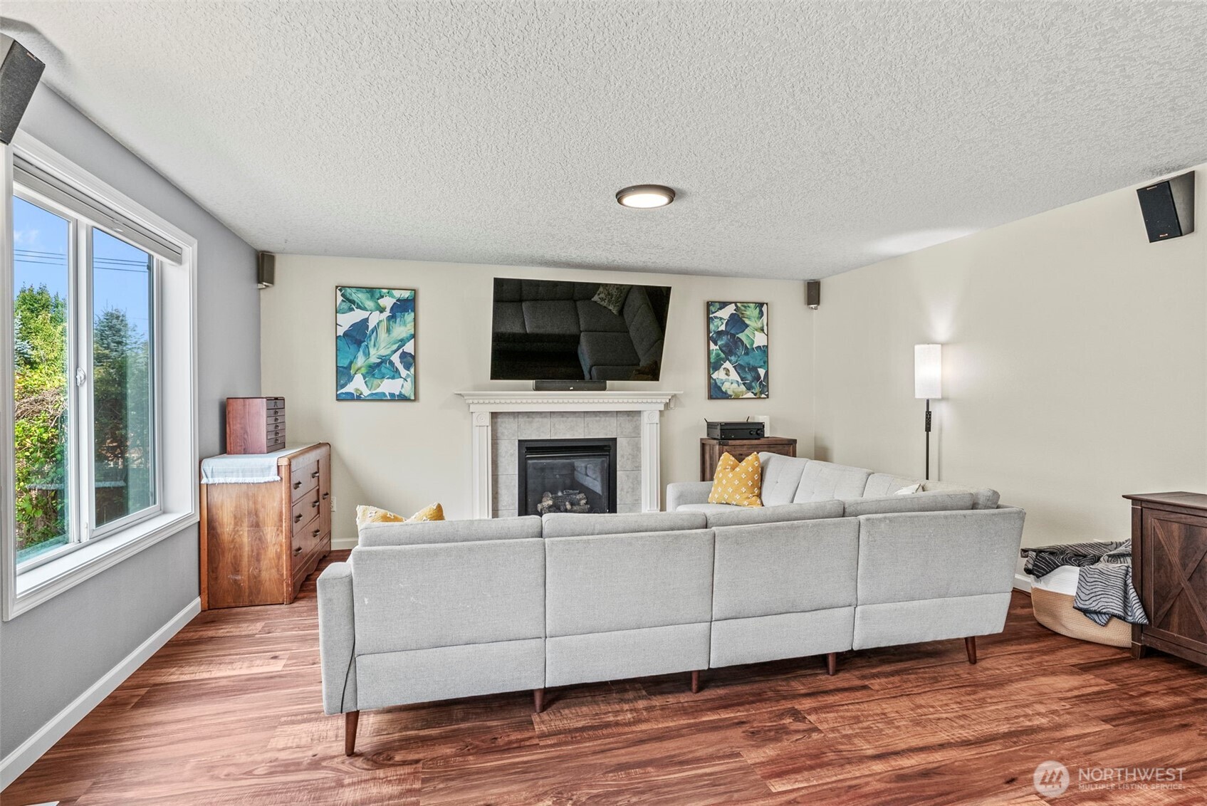 2410 North Heron Drive Ridgefield, WA 98642 - Photo 3 of 40 a living room with furniture a flat screen tv and a fireplace