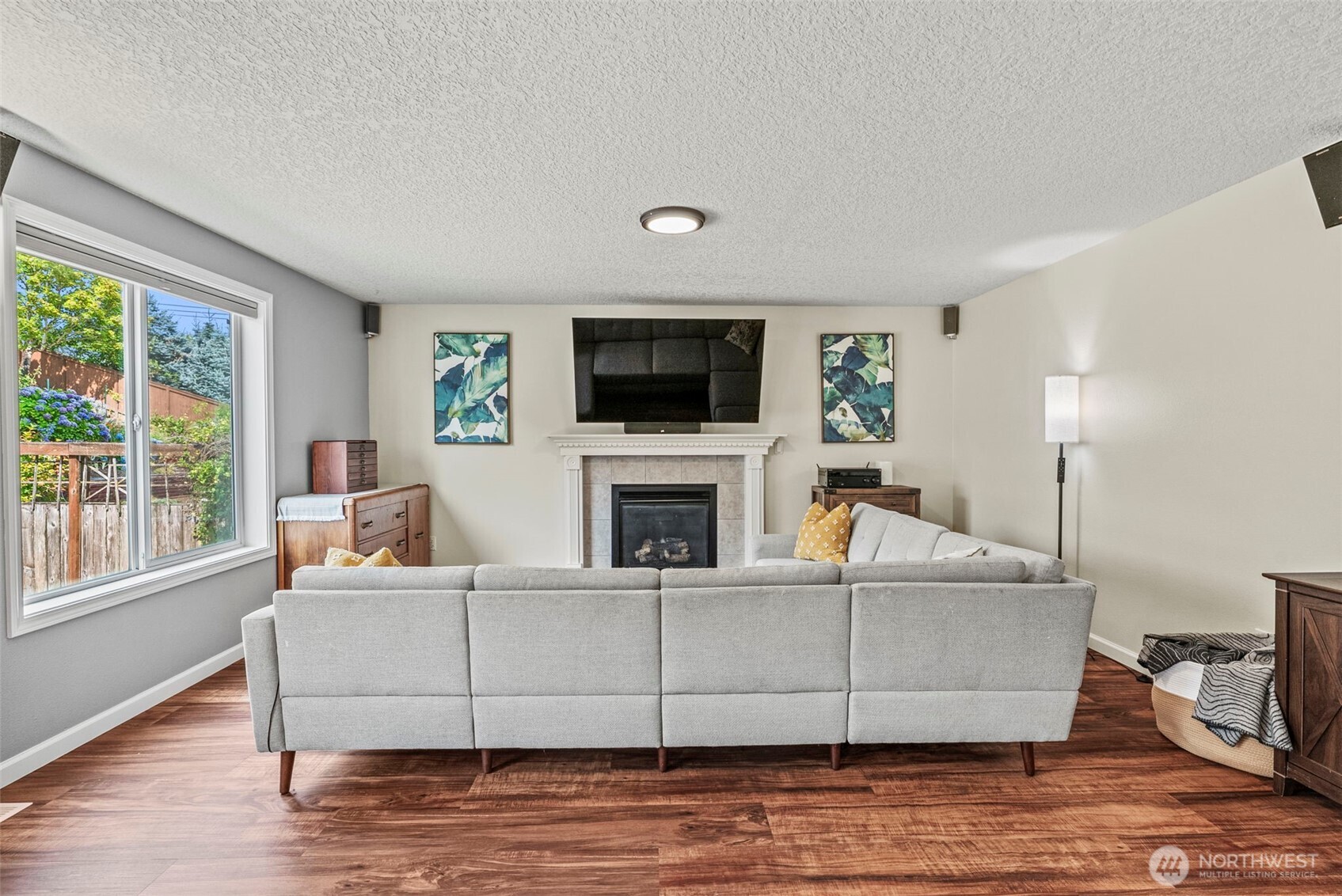 2410 North Heron Drive Ridgefield, WA 98642 - Photo 5 of 40 a living room with furniture a flat screen tv and a fireplace