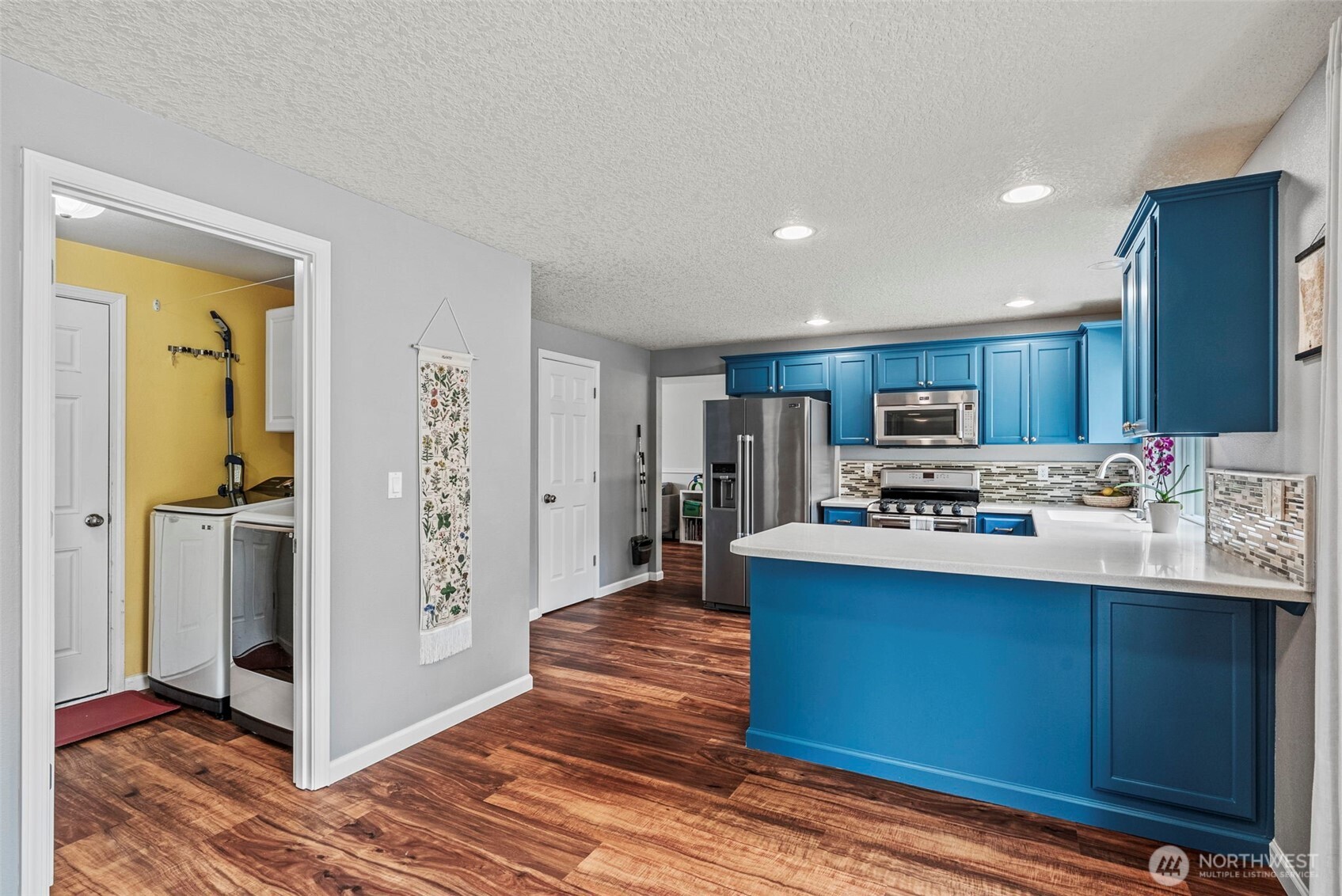 2410 North Heron Drive Ridgefield, WA 98642 - Photo 6 of 40 a view of kitchen with stainless steel appliances granite countertop a refrigerator and a stove top oven