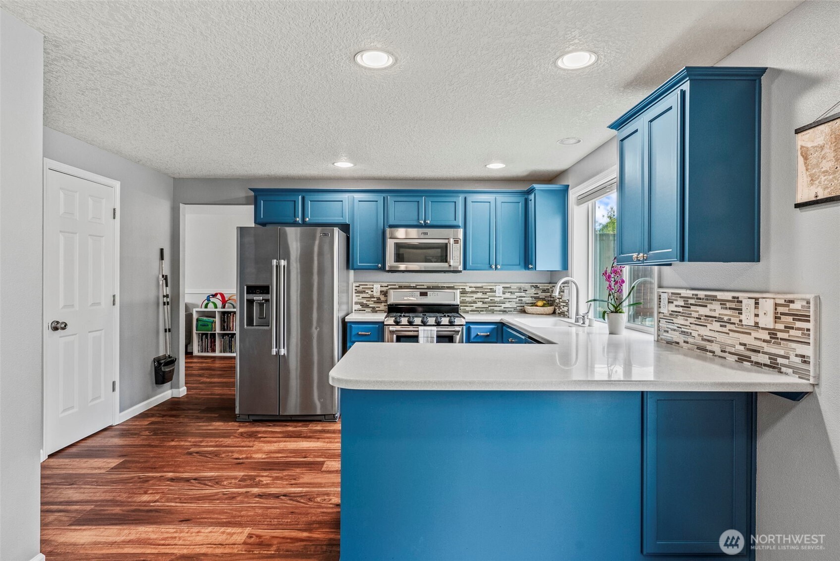 2410 North Heron Drive Ridgefield, WA 98642 - Photo 7 of 40 a kitchen with stainless steel appliances granite countertop a refrigerator and a stove top oven