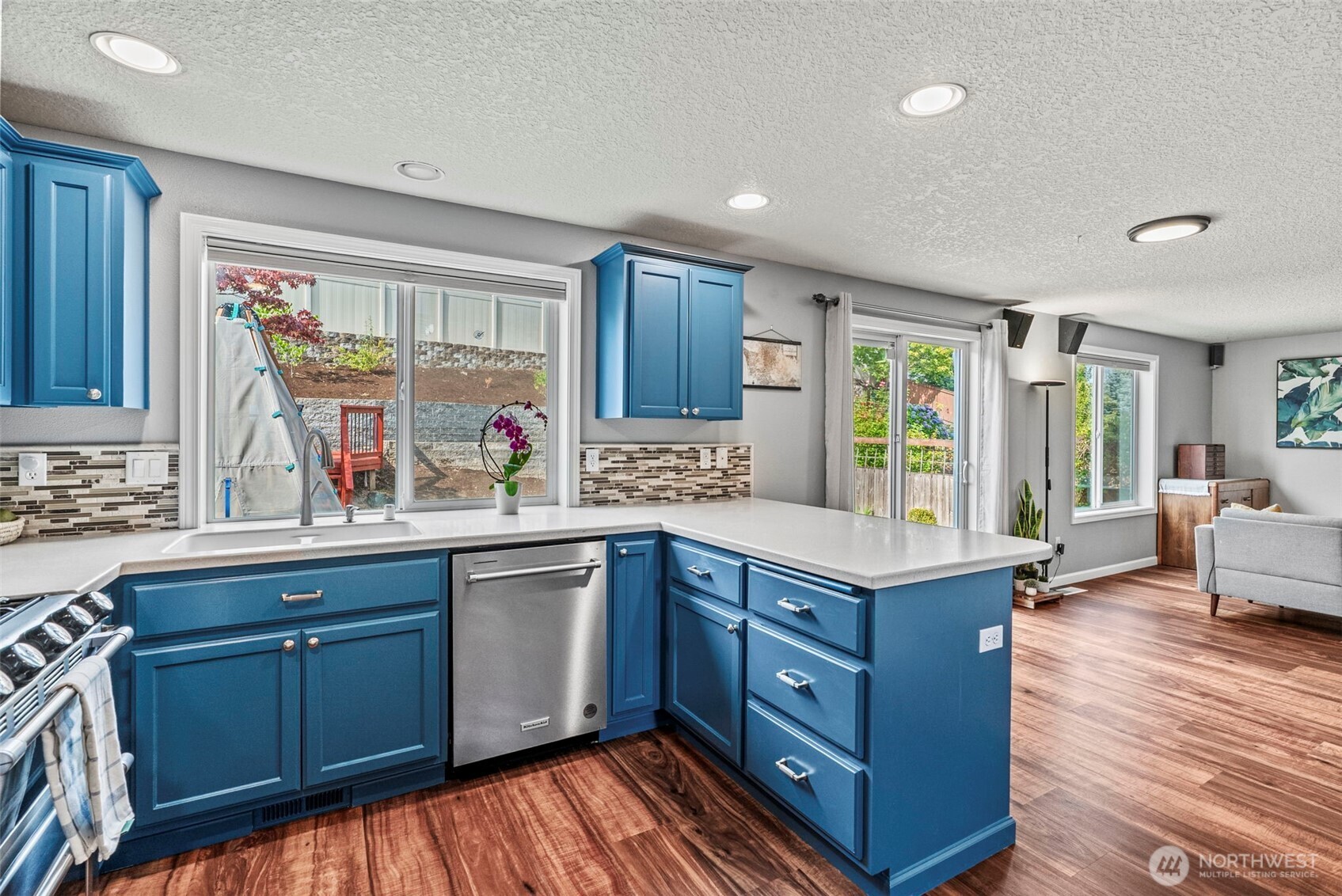 2410 North Heron Drive Ridgefield, WA 98642 - Photo 10 of 40 a kitchen with granite countertop a sink dishwasher stove and wooden cabinets