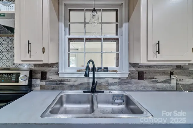 a kitchen with granite countertop a sink and a counter top space