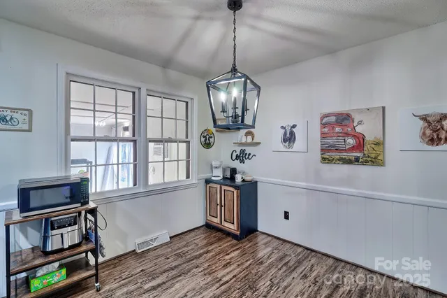 a kitchen with stainless steel appliances granite countertop a stove and a wooden floors