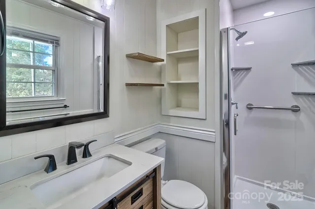 a bathroom with a sink toilet and shower