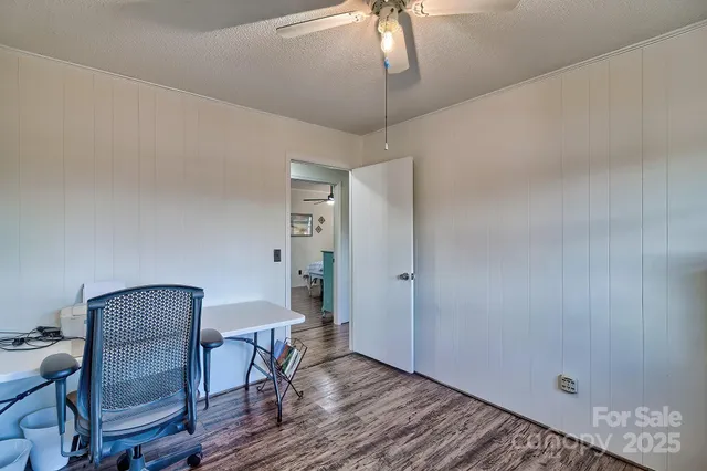 a workspace room with furniture and wooden floor