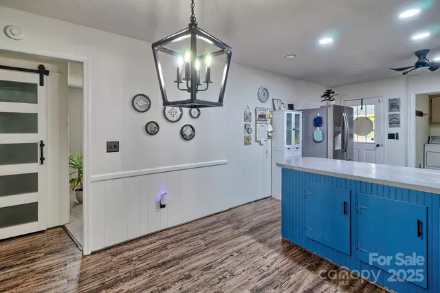 a hallway with painting and wooden floor