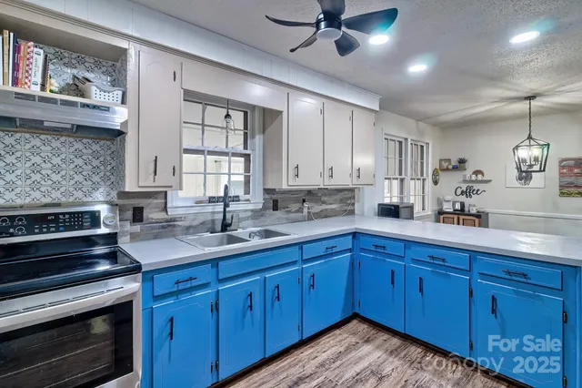a kitchen with sink and cabinets
