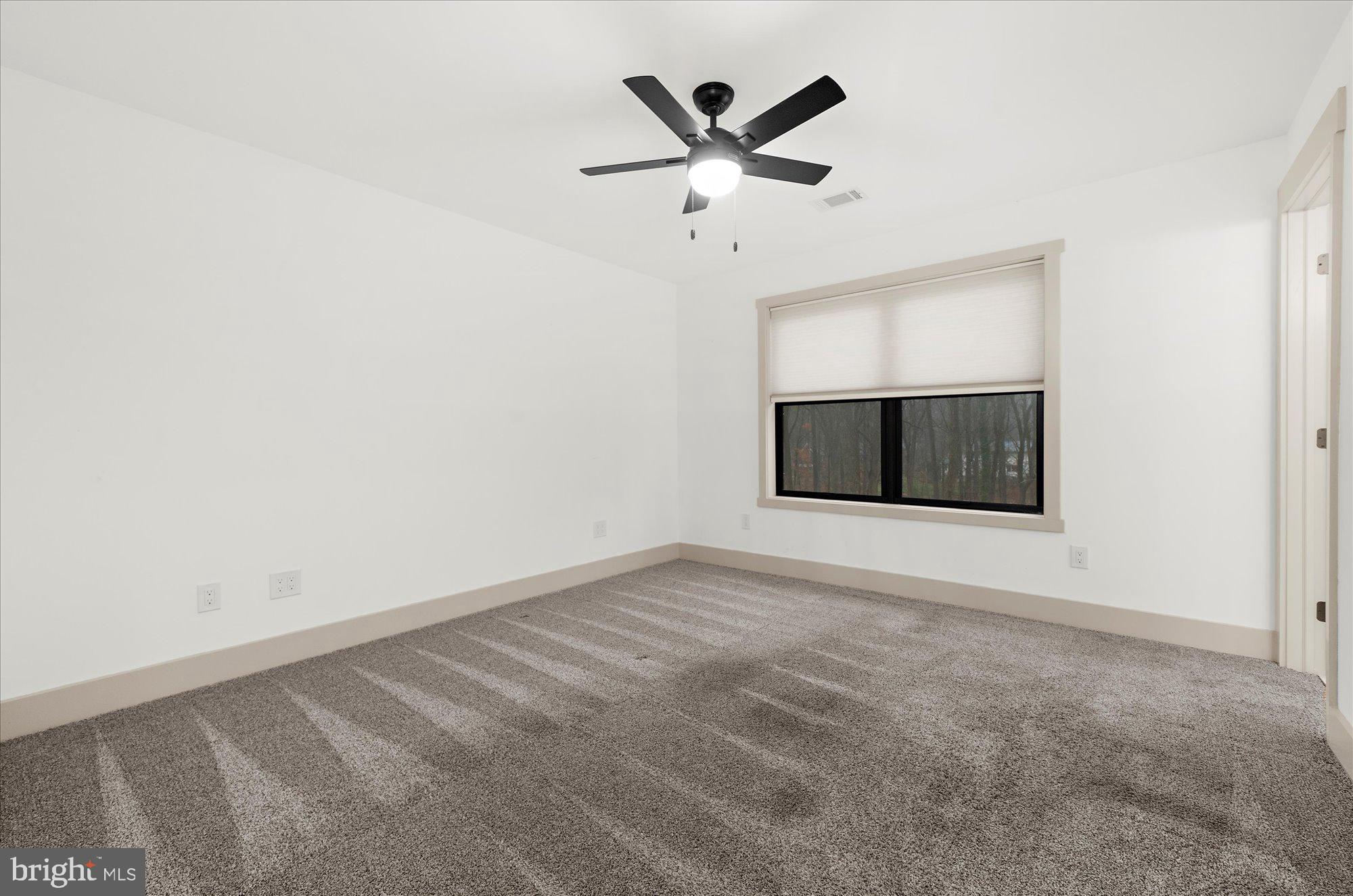 8 Chipmunk Lane Media, PA 19063 - Photo 30 of 51 an empty room with a ceiling fan and a window