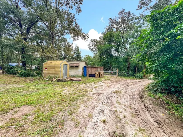 a backyard of a house with a garden and deck