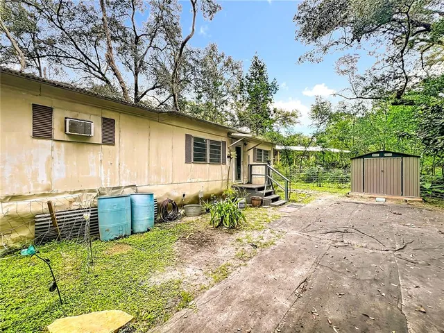 a backyard of a house with yard and outdoor seating