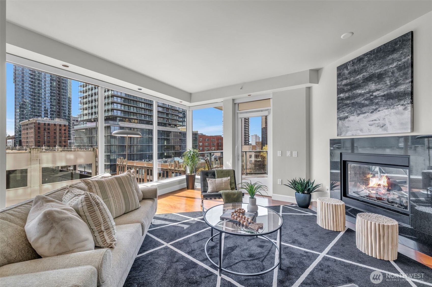 1920 4th Avenue, Unit 602 Seattle, WA 98101 - Photo 13 of 35 a living room with furniture a fireplace and floor to ceiling windows