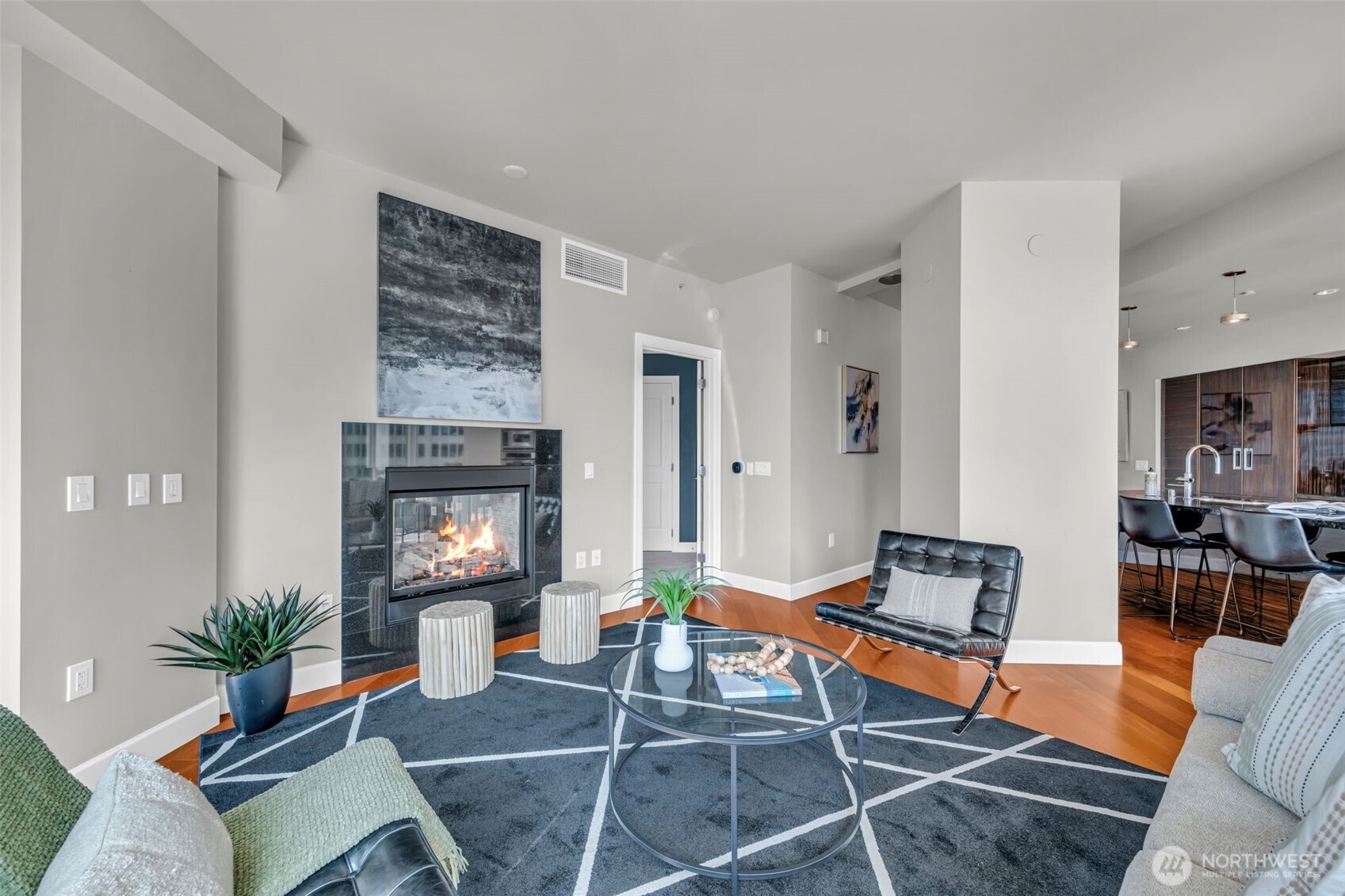 1920 4th Avenue, Unit 602 Seattle, WA 98101 - Photo 15 of 35 a living room with furniture a potted plant and a fireplace