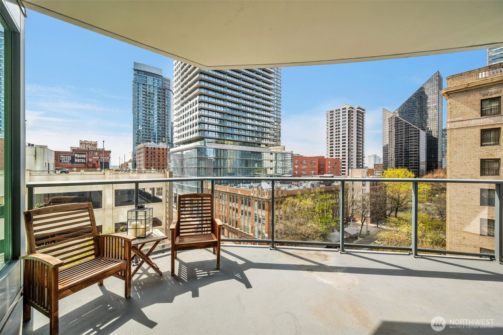 1920 4th Avenue, Unit 602 Seattle, WA 98101 - Photo 16 of 35 a view of balcony with chairs and wooden floor
