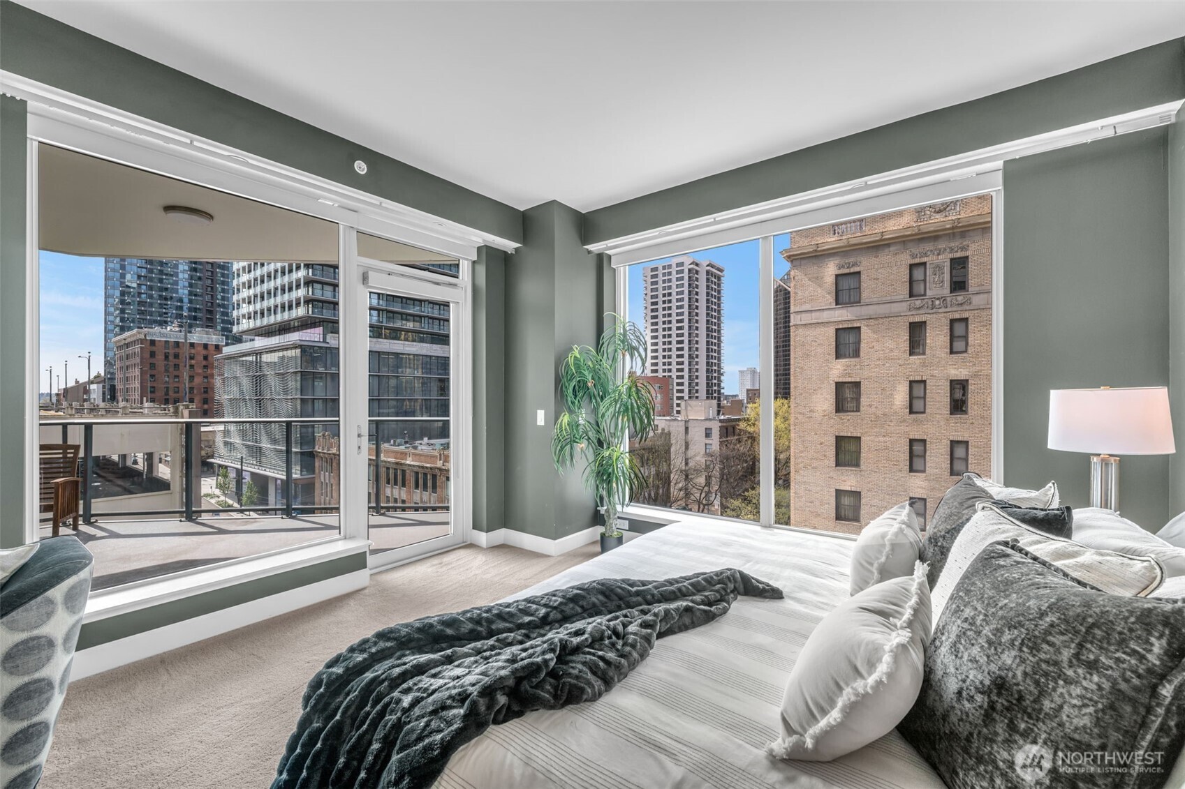 1920 4th Avenue, Unit 602 Seattle, WA 98101 - Photo 19 of 35 a bedroom with a large bed and a large window