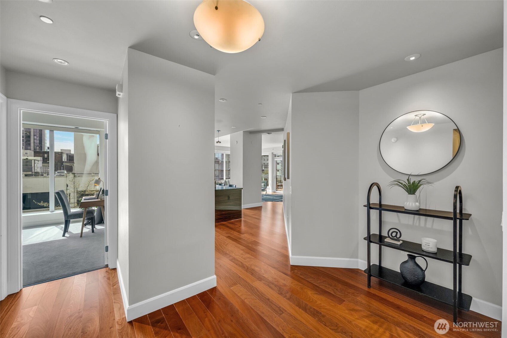 1920 4th Avenue, Unit 602 Seattle, WA 98101 - Photo 2 of 35 wooden floor in an empty room with a mirror