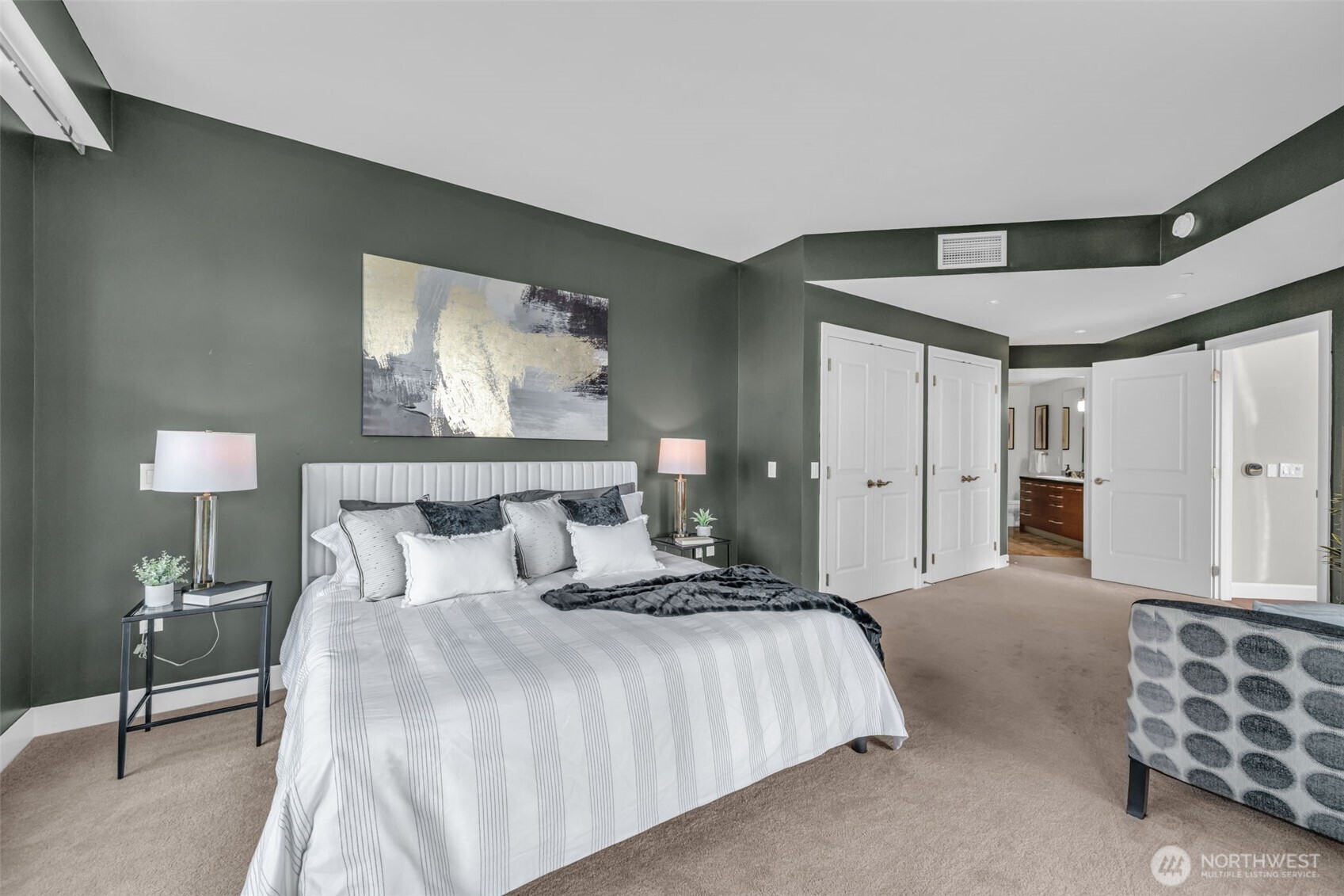 1920 4th Avenue, Unit 602 Seattle, WA 98101 - Photo 21 of 35 a spacious bedroom with a bed and a lamp