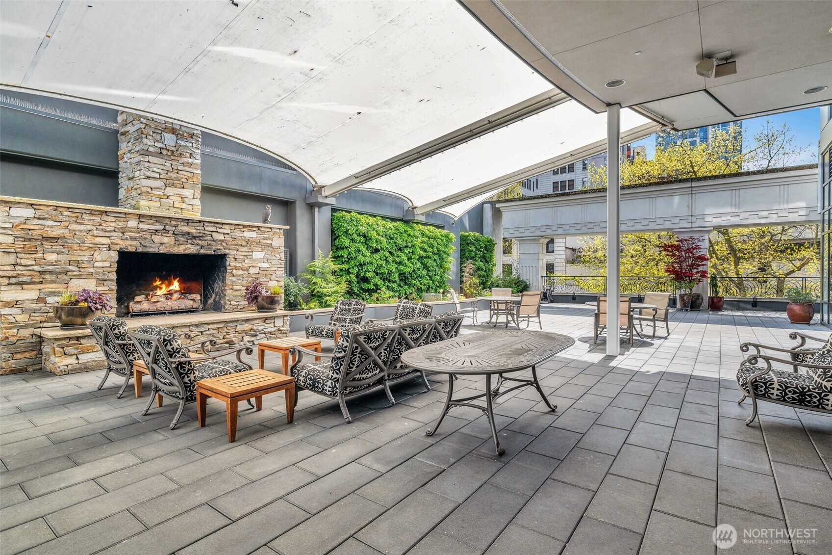 1920 4th Avenue, Unit 602 Seattle, WA 98101 - Photo 32 of 35 a view of a patio with dining table and chairs with a fire pit