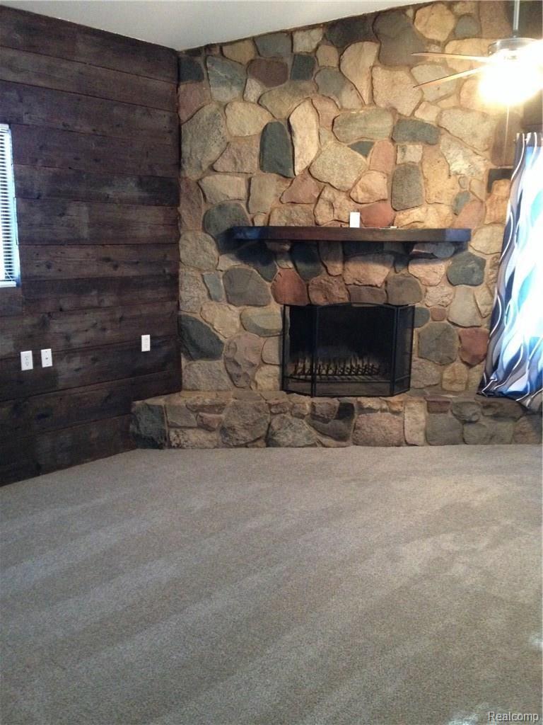 3205 Cat Lake Road Caro, MI 48723 - Photo 2 of 10 Large living with natural stone wood burning fireplace.