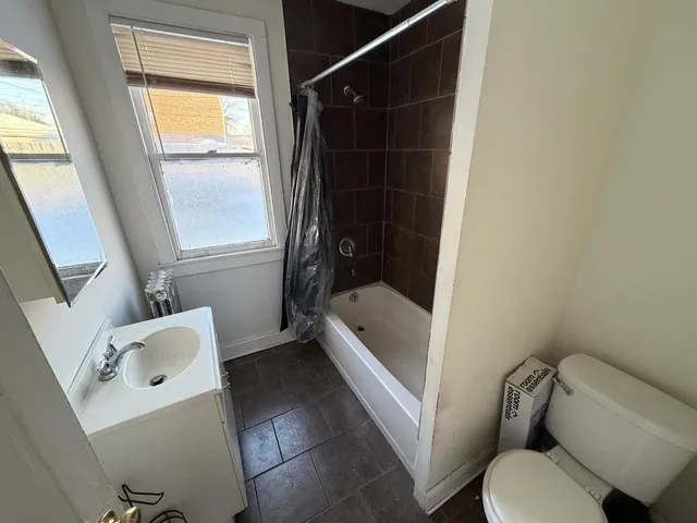 a bathroom with a toilet and a bath tub
