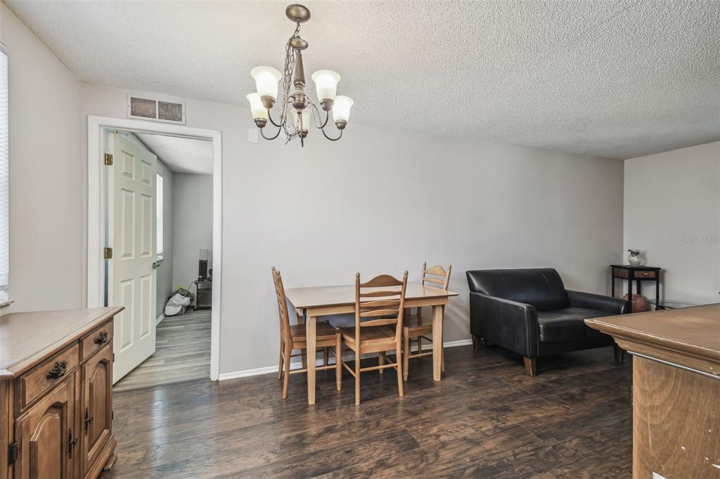 8710 St Regis Lane Port Richey, FL 34668 - Photo 14 of 39 Dining area leads to primary bedroom