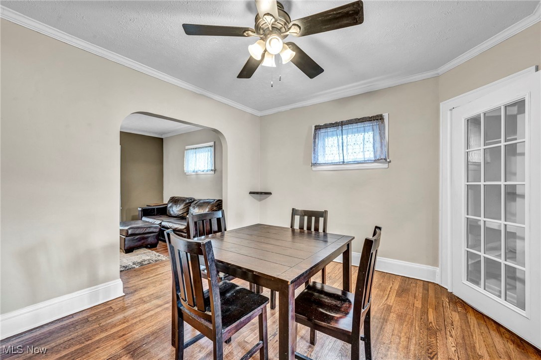 14725 Alger Road Cleveland, OH 44111 - Photo 9 of 40 Dining room featuring ornamental molding, wood-type flooring, and a wealth of natural light