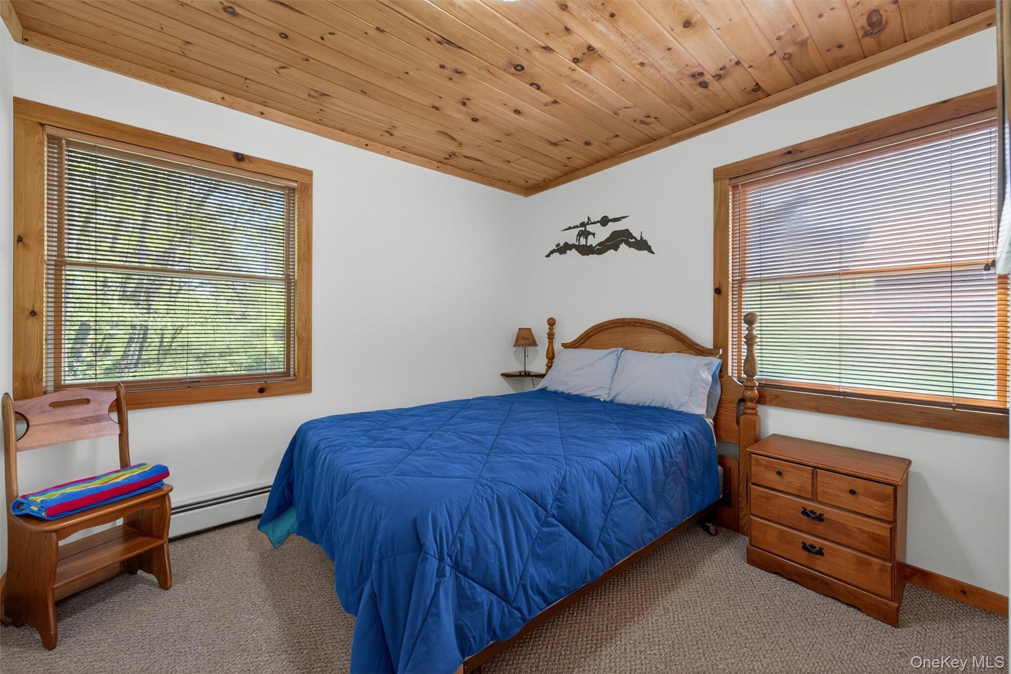 340 Hospital Road Callicoon, NY 12723 - Photo 24 of 41 a bedroom with a bed and a dresser next to a window