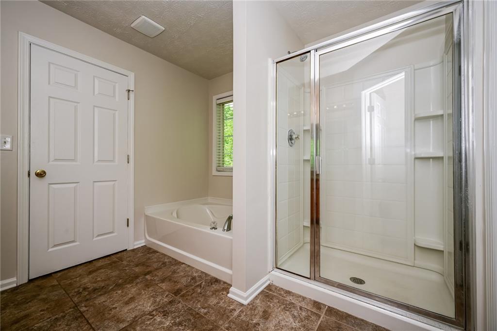 4468 Abram Way Conley, GA 30288 - Photo 9 of 23 a bathroom with a bathtub and a shower