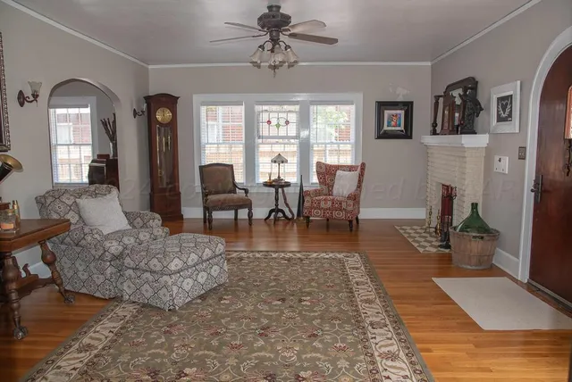 a living room with furniture and wooden floor