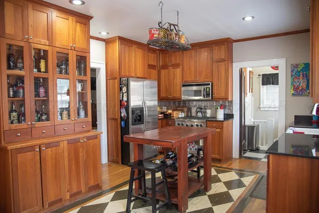 a bed sitting in a bedroom next to a lamp with a chandelier