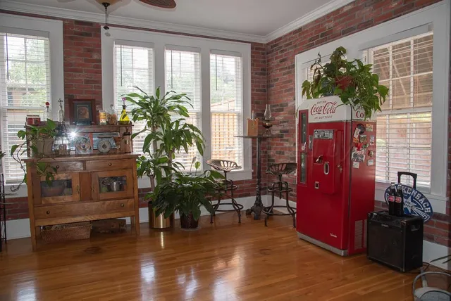 an aerial view of residential houses with outdoor space and trees