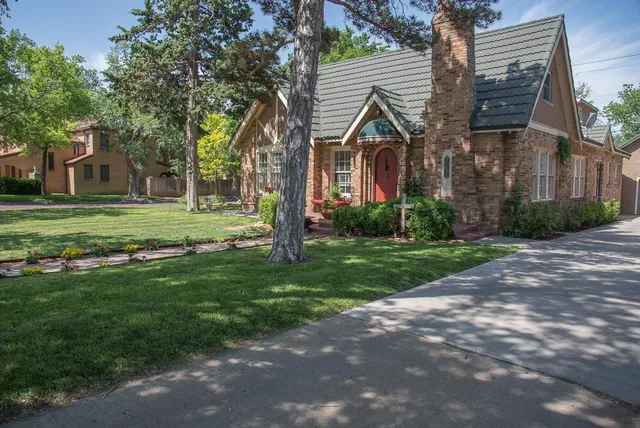 front view of a house with a tree in a yard