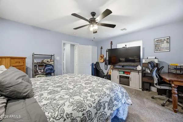 a bedroom with a bed and a flat screen tv