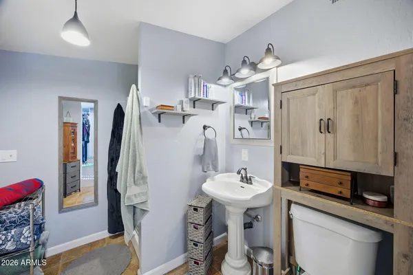 a bathroom with a sink a mirror and a shower