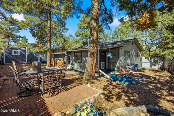 a view of a patio with table and chairs and potted plants
