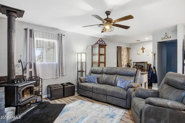 a living room with furniture ceiling fan and a window