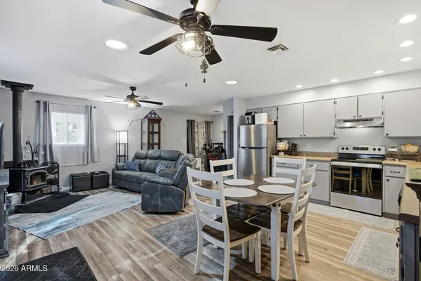 a living room with stainless steel appliances kitchen island granite countertop furniture and a kitchen view