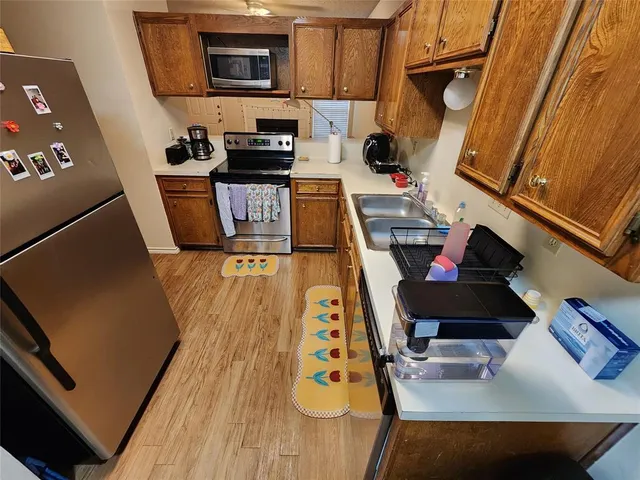 a kitchen with microwave a stove and cabinets