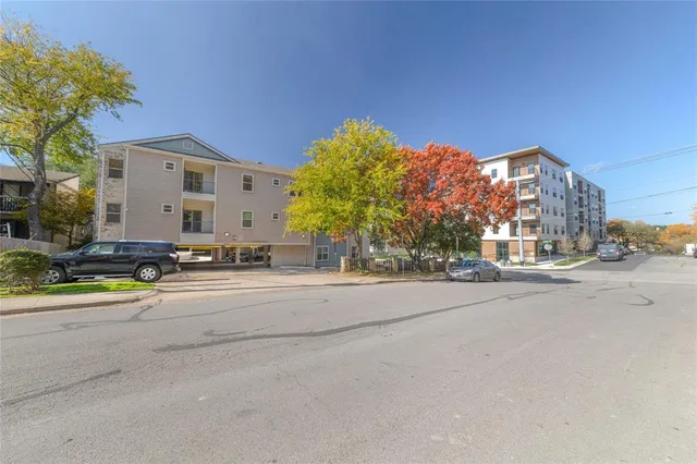 a front view of a house with a yard and a garage
